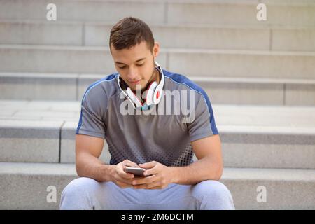 Smartphone cell phone listening to music young latin man listen Stock Photo