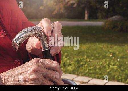 Seniors old hands with walking stick Stock Photo
