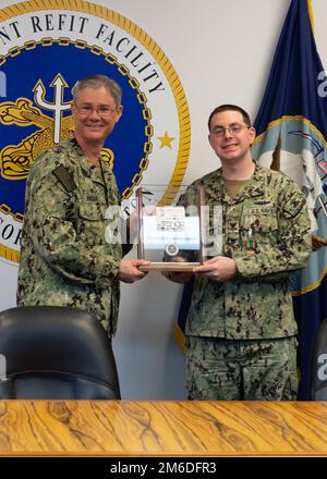 SILVERDALE, Wash. (Apr. 25, 2022) –U.S. Navy Capt. Robert Figgs (left), commanding officer, Trident Refit Facility, Bangor (TRFB), presents Sonar Technician Submarine 1st Class Ryan Vankoningsveld, from Bangor, Wisc., with the 2021 USS Thresher Memorial Award. Vankoningsveld was selected as the 2021 USS Thresher Memorial Award military recipient. The annual USS Thresher Memorial Award recognizes individuals whose contribution most positively influenced the culture, processes, and execution of the SUBSAFE program at TRFB. Stock Photo