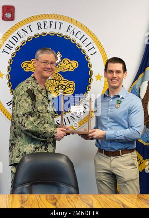 SILVERDALE, Wash. (Apr. 25, 2022) –U.S. Navy Capt. Robert Figgs (left), commanding officer, Trident Refit Facility, Bangor (TRFB), presents Billy F. Albert (right), supervisory mechanical engineer at TRFB, with the 2021 USS Thresher Memorial Award. Albert was selected as the 2021 USS Thresher Memorial Award supervisor recipient. The annual USS Thresher Memorial Award recognizes individuals whose contribution most positively influenced the culture, processes, and execution of the SUBSAFE program at TRFB. Stock Photo