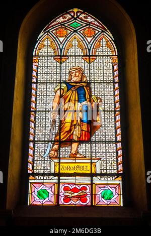Coloured stained glass window colored in a dark background church with Zerubbabel bible character Stock Photo