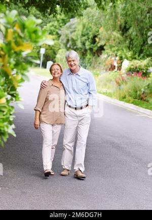 We complete each other. Portrait of a cheerful senior couple taking a stroll. Stock Photo