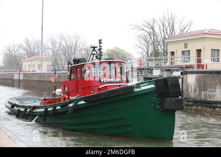 The tugboat Vermont departs the Black Rock Lock and enters the Black Rock Channel in Buffalo, New York, April 25, 2022. The New York escorted the first major vessel of the commercial shipping season through the lock, which provides the only means for deep draft commercial vessels on the Great Lakes to reach delivery ports on the upper Niagara River. Stock Photo