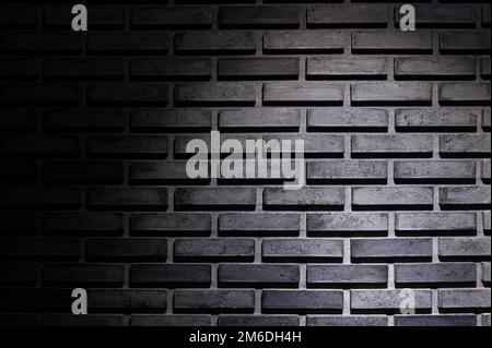 Black brick wall background with light spot Stock Photo