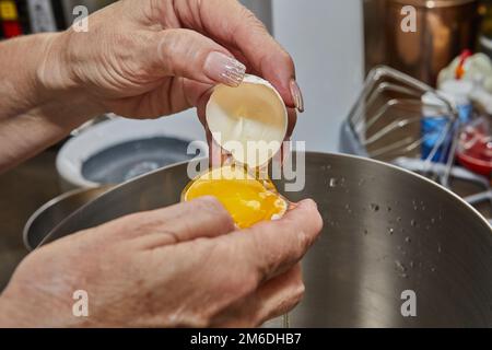 Chef separates the yolk from the protein to make the pie. Stock Photo