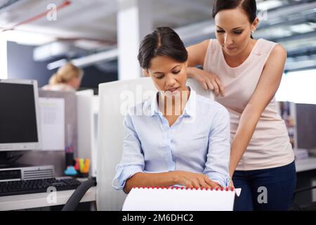 Going over the designs together. two female designers working together in the office. Stock Photo