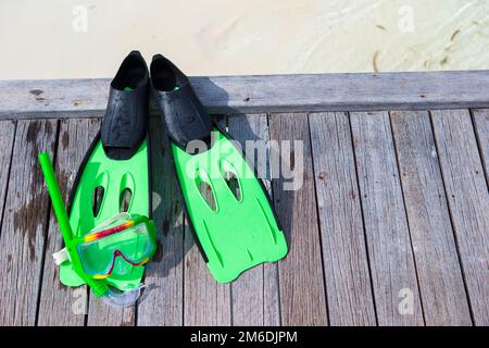 Mask, snorkel and fins for snorkeling on wooden jetty Stock Photo