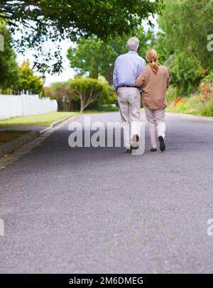 Theres no I in us. Low angle shot of a senior couple walking together. Stock Photo