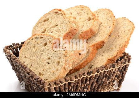 Sliced loaf of bread in a basket isolated on white Stock Photo