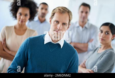 Team focus. Portrait of a group of diverse colleagues standing in an office. Stock Photo
