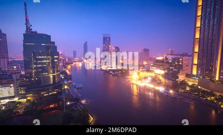 Aerial view Bangkok city skyline at night over Chao Praya River Stock Photo