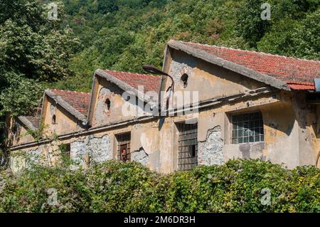 Old obsolete industrial building facade with broken windows Stock Photo
