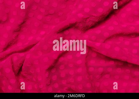 Texture of fabric. Beautiful knitted repeating pattern. Demonstrating Pantone color of the year 2023 viva magenta. Stock Photo