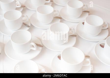 Group of coffee cups in cafe bar on the white tablecloth Stock Photo