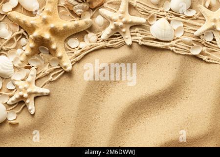 Seashells And Starfishes On Sand Background Stock Photo