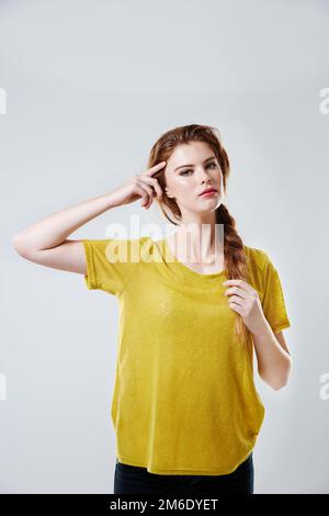 That ones a thinker. Studio shot of a casually dressed young woman. Stock Photo