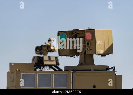 Packed with cameras, passive sensors, 3D detection, radar, and optical systems, as well as tracking capabilities, the P-HEL is one of several prototypes that allows a commander and gunner to attack a drone or target with the laser. The system relies on high-powered energy to destroy its target instead of using traditional ammunition to shoot it out of the sky. U.S.,Army,Yuma,Proving,Grounds, Stock Photo