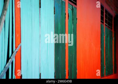 Colourful bright background of wooden walls, blue, green and red vertical and diagonal lines Stock Photo