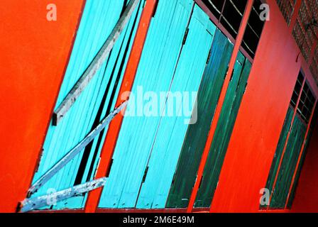 Colourful bright background of wooden walls, blue, green and red vertical and diagonal lines Stock Photo
