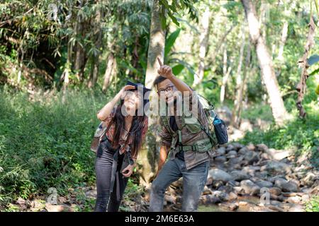 Backpack tourist travel outdoor adventure bird study using binoculars looking and record to book Stock Photo