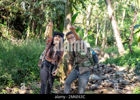 Backpack tourist travel outdoor adventure bird study using binoculars looking and record to book Stock Photo