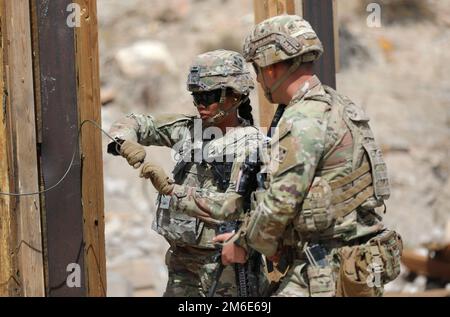 Soldiers with Company A, 52nd Brigade Engineer Battalion, 2nd Stryker Stryker Brigade Combat Team, 4th Infantry Division, prepare an explosive to breach a door during demolition training April 26 at Fort Carson, Colo. Squads from each platoon went over and refined their skills in breaching doors and clearing rooms using explosives. Stock Photo