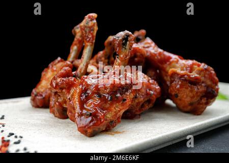 Barbecue chicken legs with spicy sauce and black sesame Stock Photo