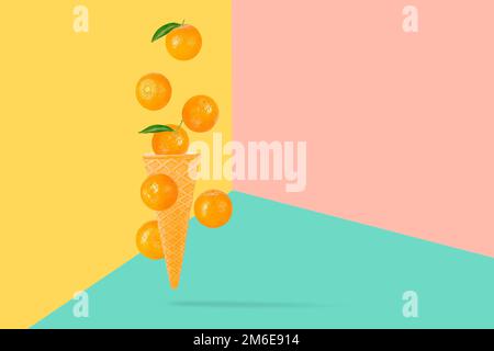 Falling ice cream cone with mandarin fruits. Seven flying whole tangerines on colored table with clipping path as package design element and advertisi Stock Photo