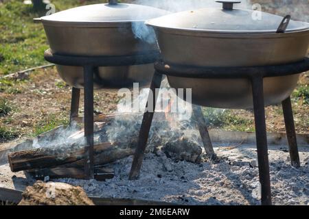 Cauldron or camping kettle over open fire outdoors Stock Photo - Alamy