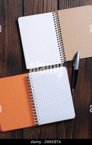 Opened notebook and pen on wooden background, top view Stock Photo