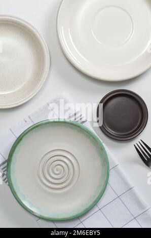 Various empty plates on white table, top view Stock Photo