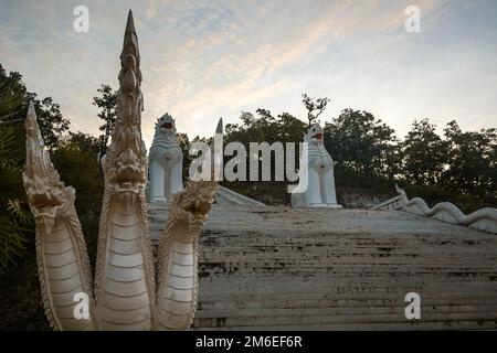 Statues guarding the White Buddha Temple in Pai, Northern Thailand Stock Photo