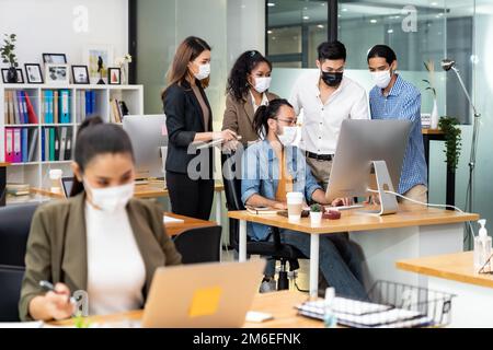 Asian business team working in new normal and social distance office Stock Photo