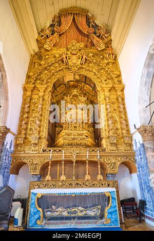 A view of the amazing, gold, rich, wood carved Baroque altar with tiny angel head decoration. A dead Jesus is in a glass case. At the Igreja da Miseri Stock Photo