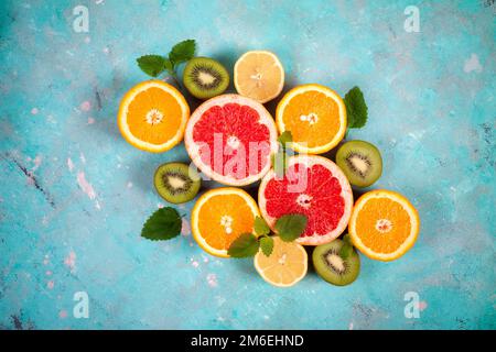 Citrus fruits with orange, lemon, grapefruit and lime on blue background Stock Photo