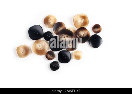 Pile, allsorts of brown old buttons on a white background Stock Photo