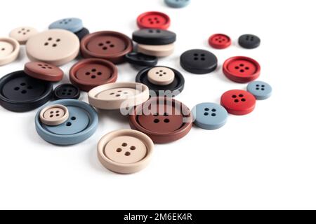 Pile of color plastic matte buttons on white, beautiful needlework Stock Photo