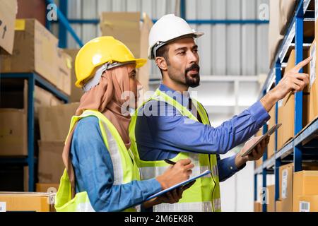 Warehouse manager talk with worker about logistic Stock Photo