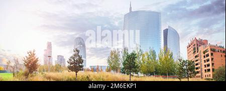 Cityscape with skyscrapers in the morning sunrise in front of a park in autumn Stock Photo