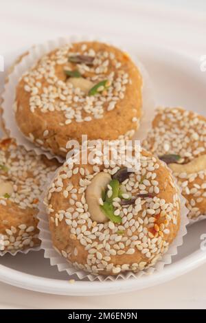 Winter Season Special Traditional Punjabi Mithai Til Tikki Or Tilkut Gud Mawa Bati Is Made Of Dry Roasted Sesame Seeds With Mava, Khoya, Jaggery, Gur, Stock Photo