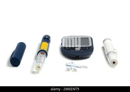 Measuring blood sugar. Glucometer with insulin pen on a white background. Isolate Stock Photo