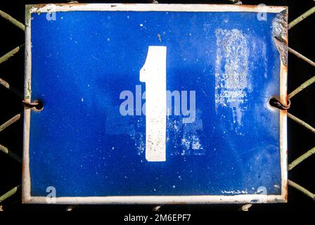 Weathered grunge square metal enameled plate of number of street address with number 1 Stock Photo