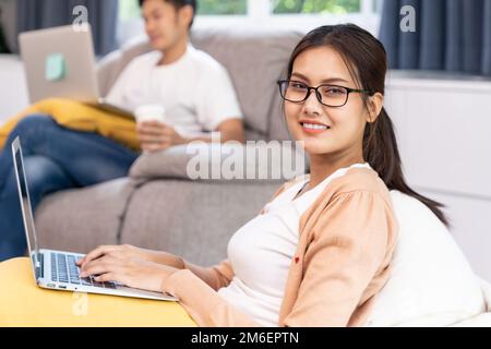 Quarantine couple working from home with laptop Stock Photo