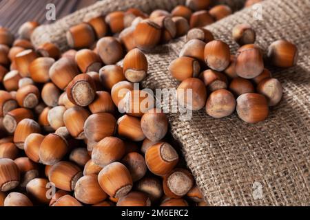 Hazelnuts, filbert on old wooden table. heap or stack of hazel nuts. Hazelnut background, healty food. Stock Photo