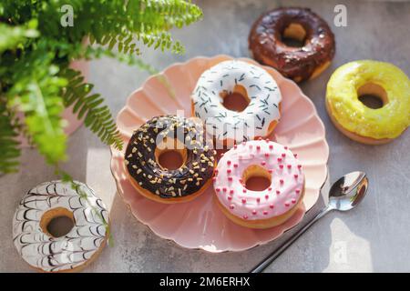 Colored different donuts with icing and topping Stock Photo