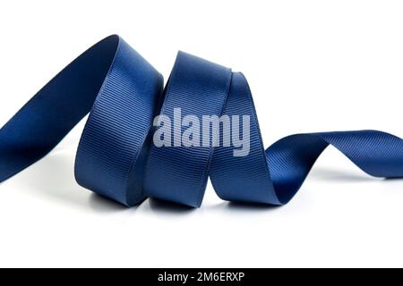 Pink, blue and white satin ribbon bows on wooden background