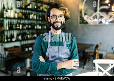 Portrait of young male business owner standing at restaurant cafe Stock Photo