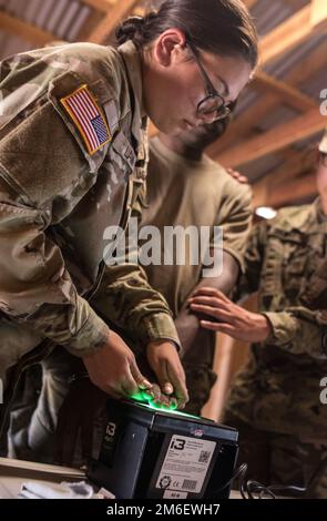 Spc. Emily Lam, an internment resettlement specialist with the 357th Military Police Company runs a fingerprint scan on a prisoner utilizing the Biometrics Automated Toolset System, which recognizes insurgents and unwanted individuals in an area, as part of Pacific Warrior. Soldiers with the 11th Military Police Brigade spent two weeks in Fort Hunter Liggett, California training on basic Army Warrior Tasks, weapons qualification, military police specific tasks, and support tasks. Army Reserve,Military Police,detainee operations, Stock Photo