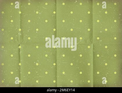 Vintage green crumpled paper with white polka dots. Old worn paper wallpaper with cracks. Stock Photo