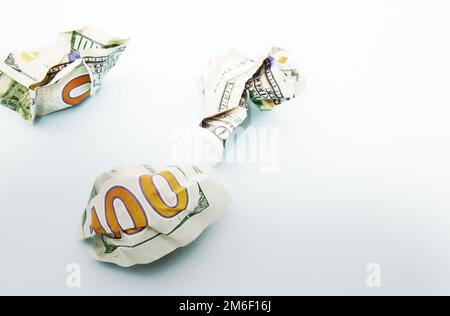 Crumpled hundred dollar bills on blue Stock Photo